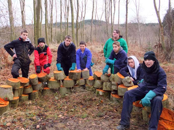 Students proudly showing their 'log wall'